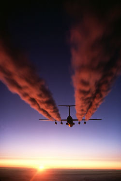 A C-141 Starlifter leaves vapour trails over Antarctica